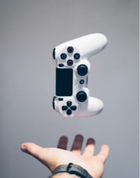 A gaming controller hovering over a hand